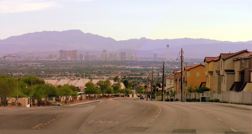 A street in the Las Vegas Valley looking toward the Strip skyline and the Spring Mountains beyond