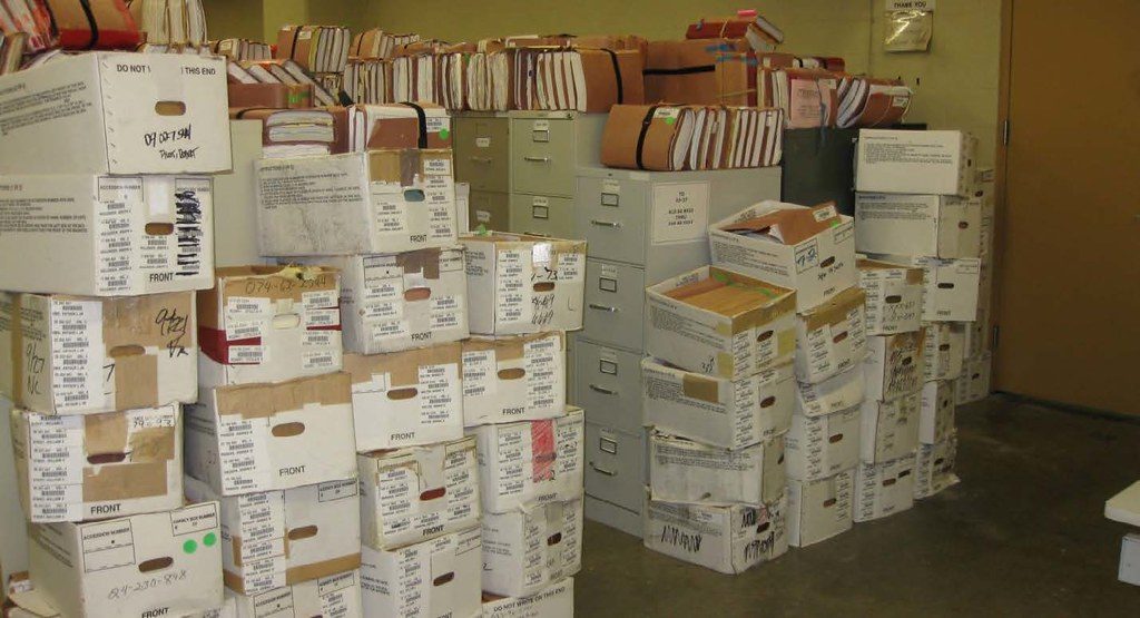 A records room stacked with boxes of aging paper files